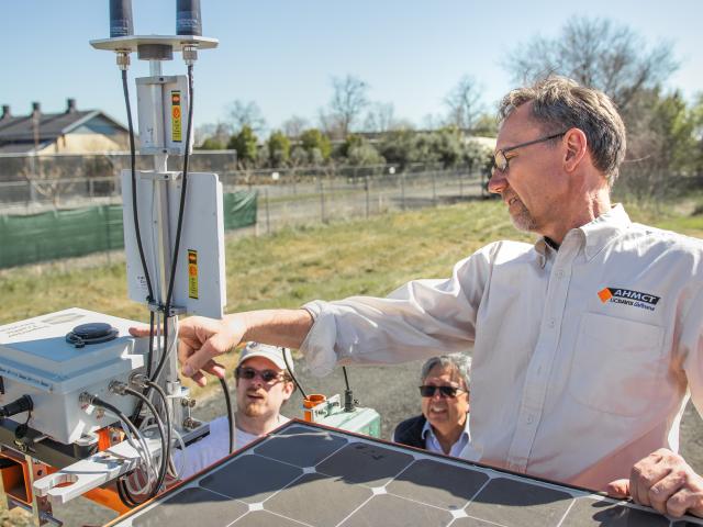 Man pointing at solar box